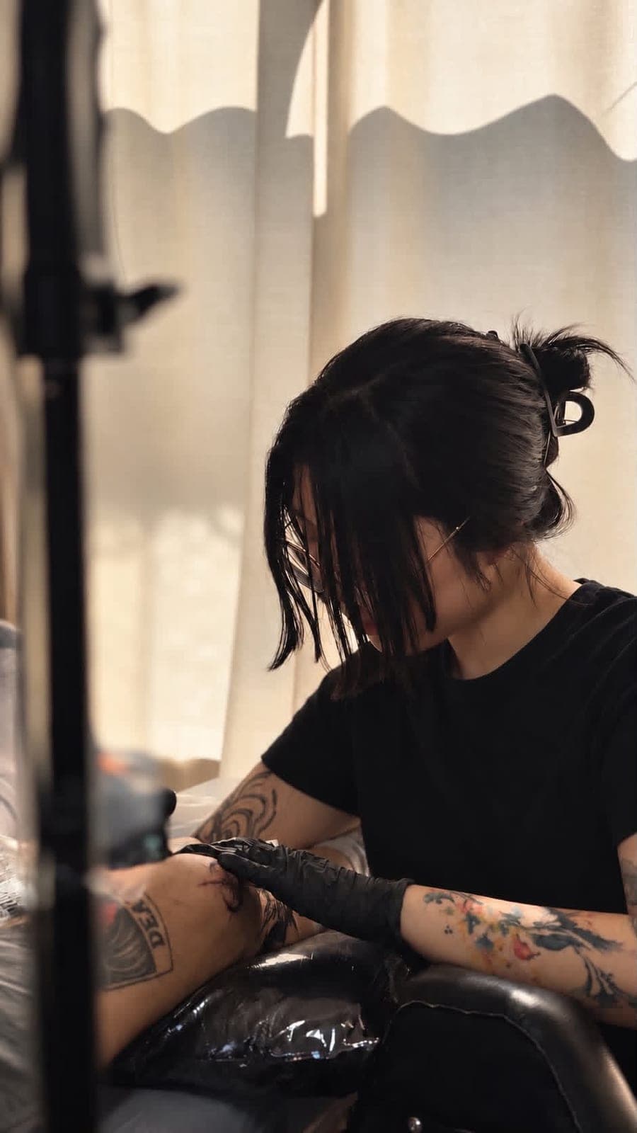 Narak tattooing a client at Nocturne Atelier