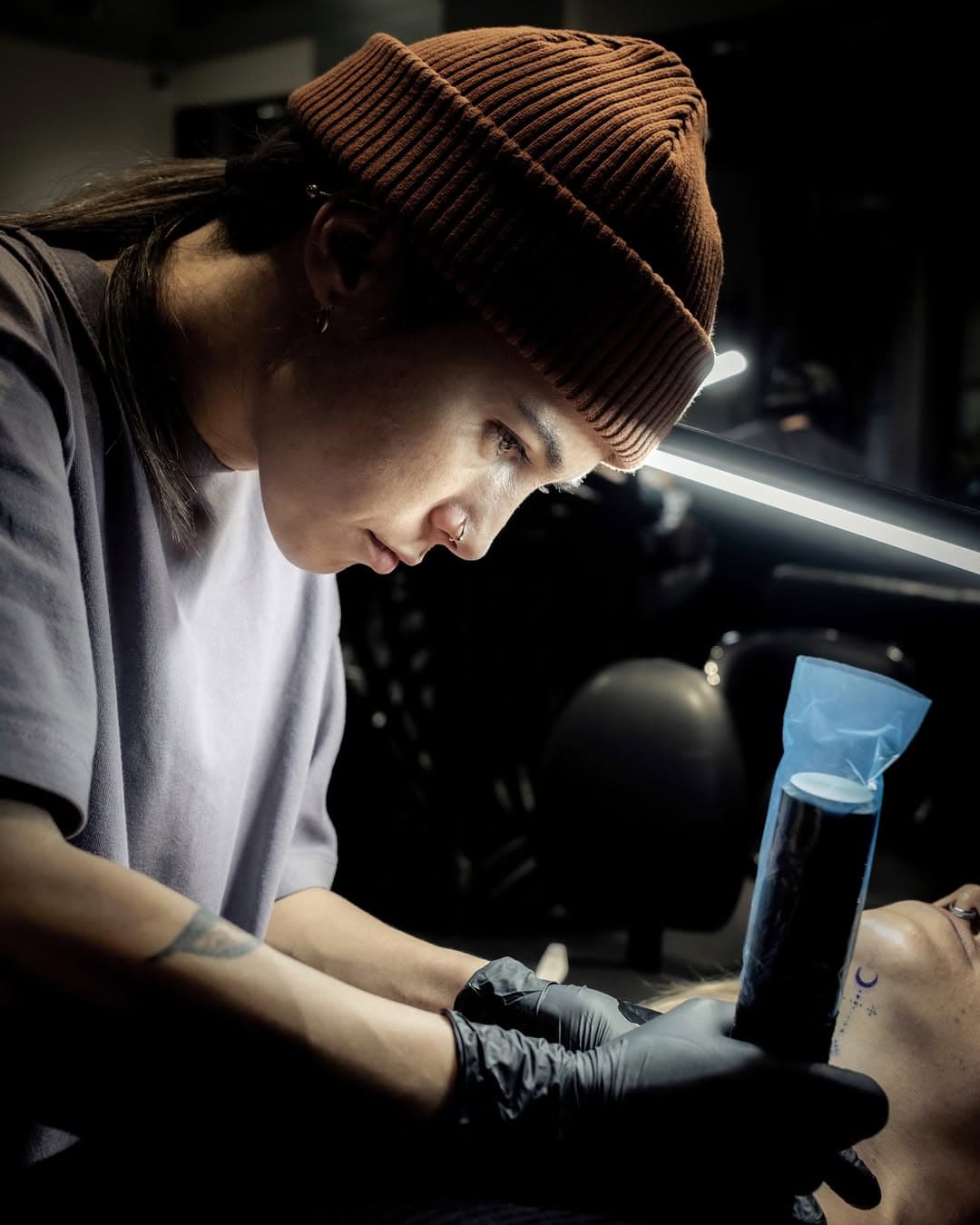 Ozlem Kocahalilogullari preparing tattoo work