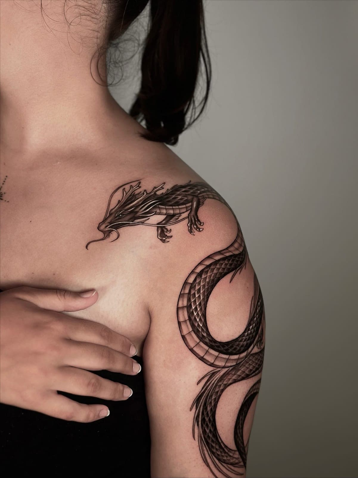 Dragon running over the shoulder and down the arm