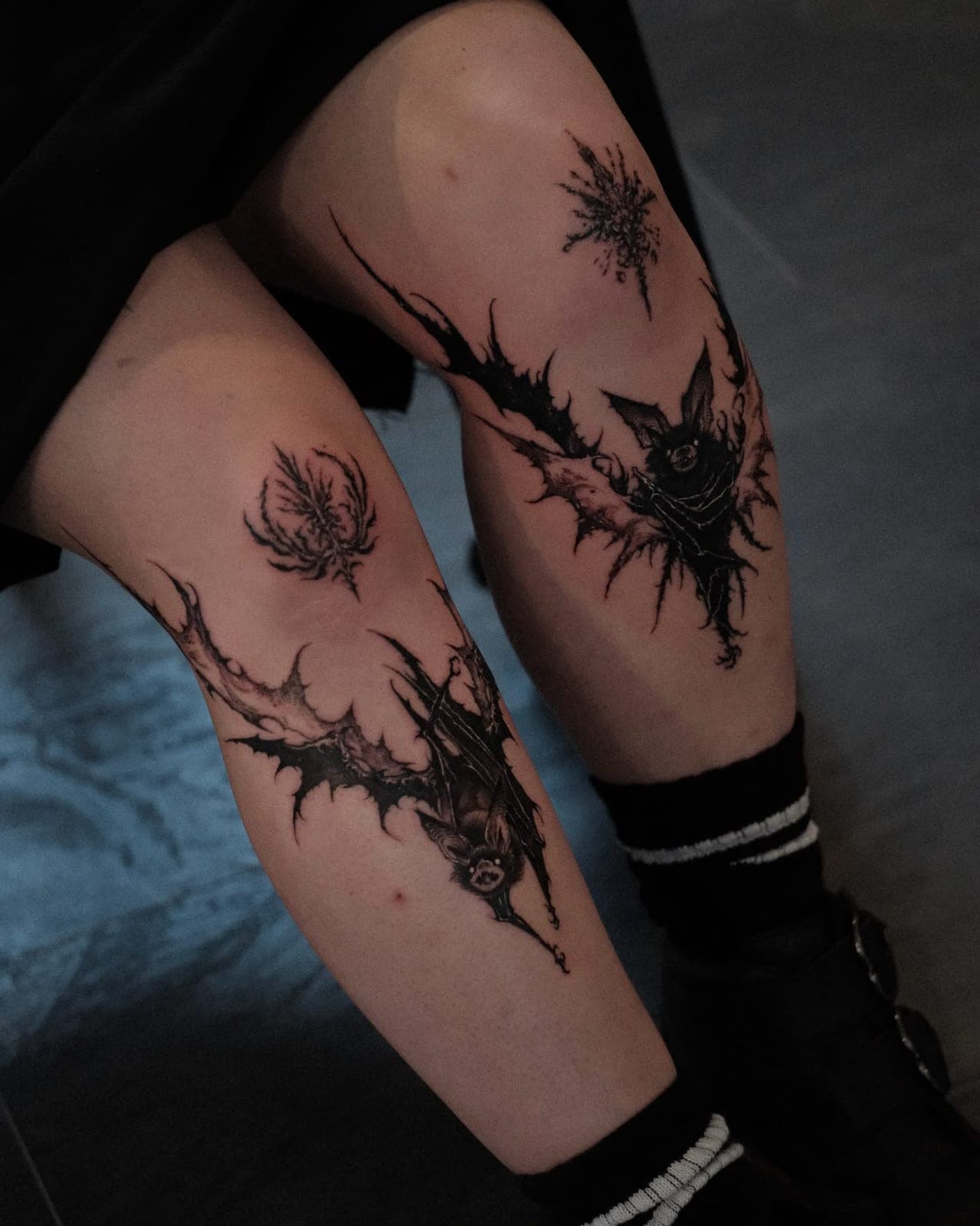 Matching blackwork pieces with thorny ornaments on both shins