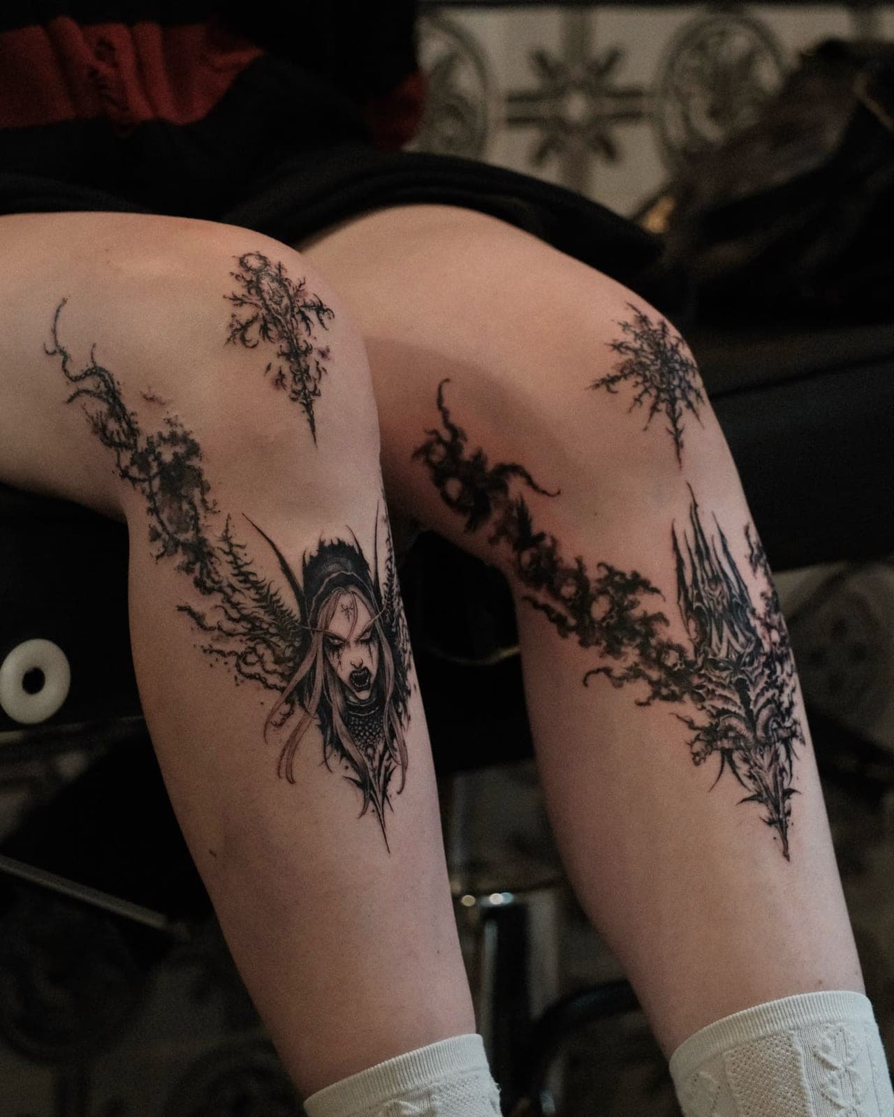 Dark fantasy blackwork portrait and ornaments on both knees