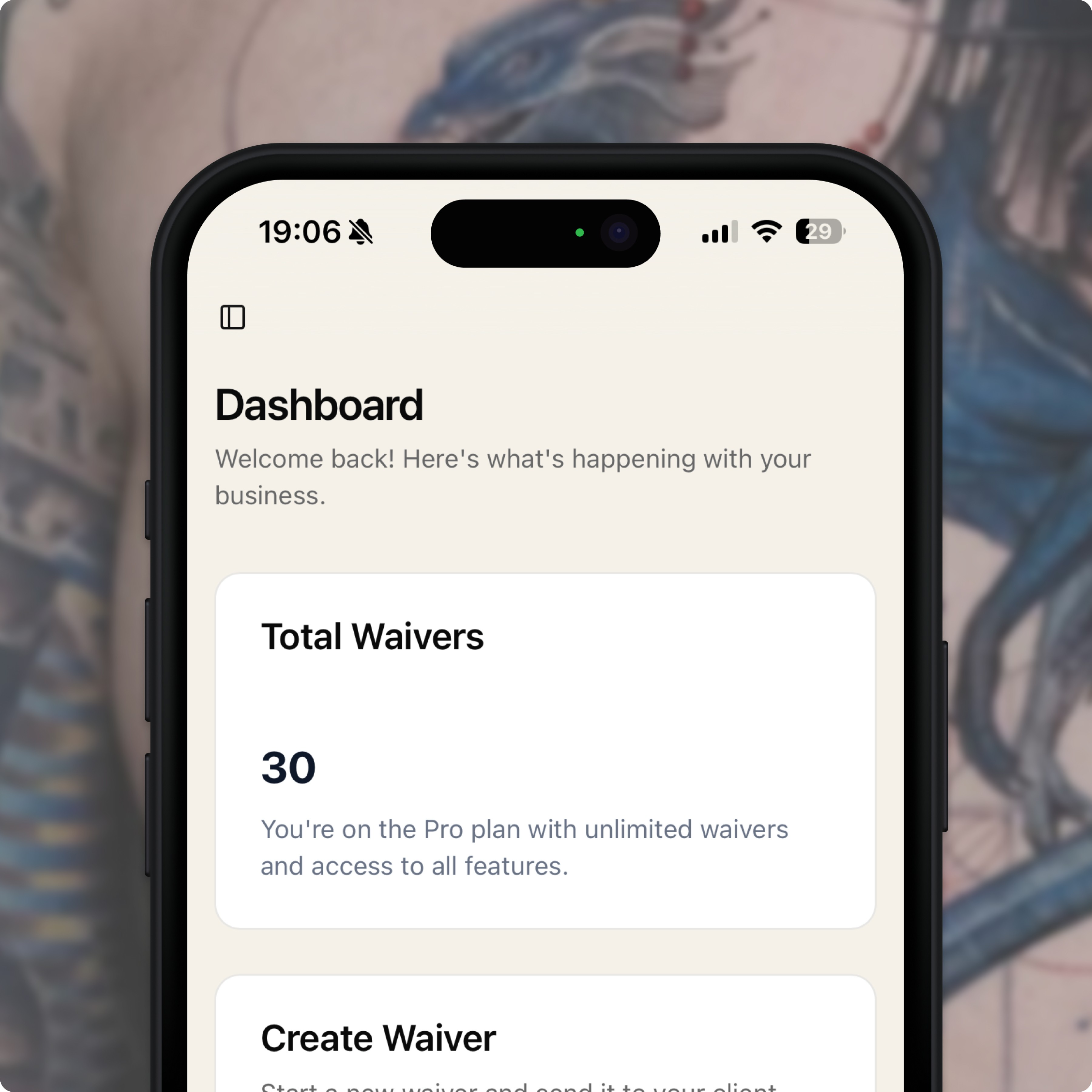 Tattoo artist reviewing digital consent on a tablet